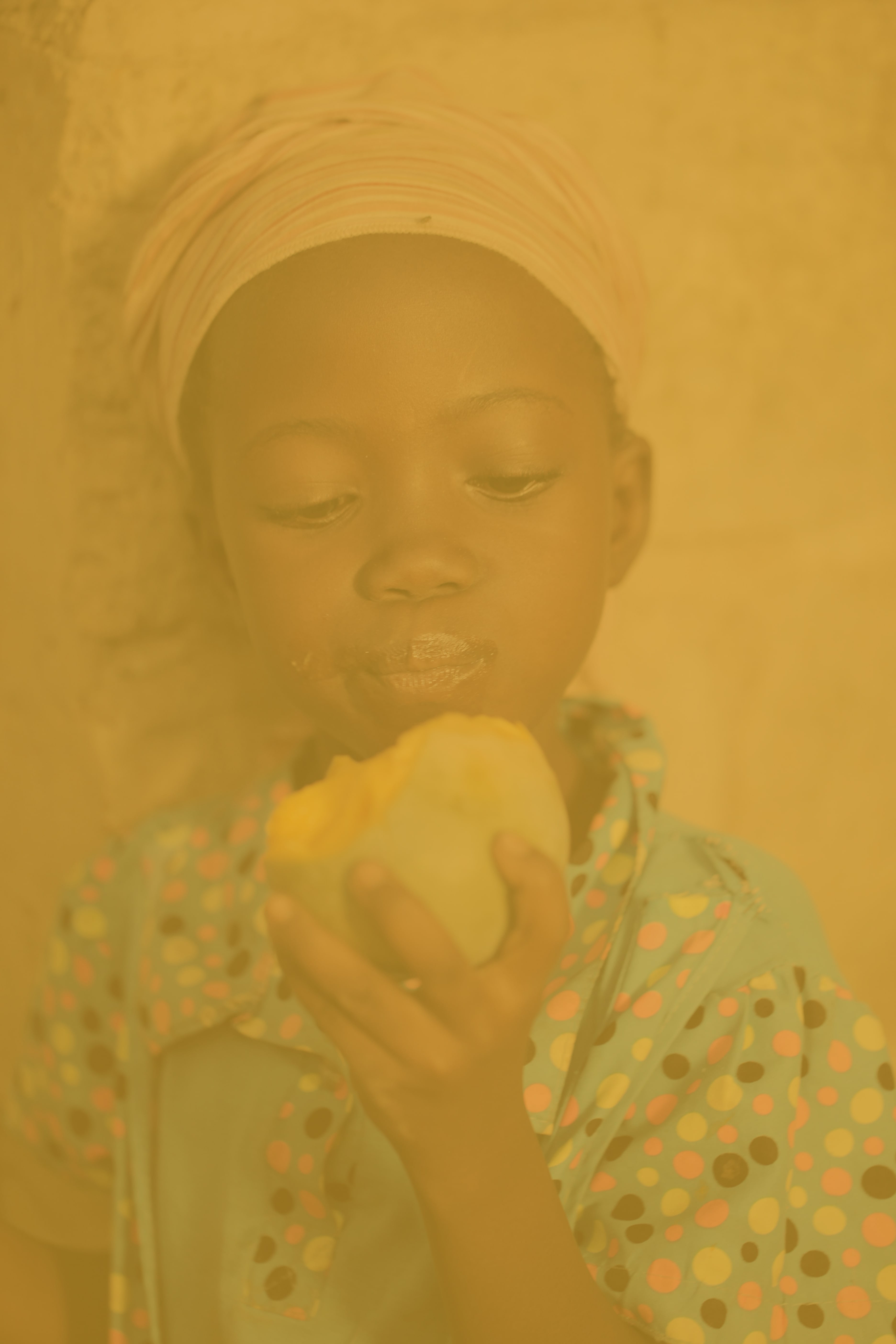 Young girl looks at a piece of food